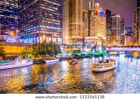 Beautiful downtown Chicago at night with lit buildings, river and bridge. Royalty-Free Stock Photo #1123565138