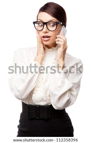 Strict woman in large glasses with a cell phone, isolated on white background