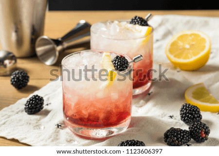 Alcoholic Blackberry Gin Bramble Cocktail with Lemon Royalty-Free Stock Photo #1123606397
