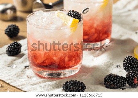 Alcoholic Blackberry Gin Bramble Cocktail with Lemon Royalty-Free Stock Photo #1123606715