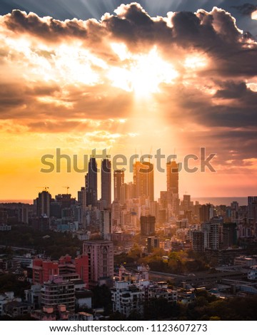 Mumbai cityscape- Crepuscular rays illuminating a part of the city.  Royalty-Free Stock Photo #1123607273