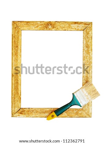 Old wooden frame with brush isolated on white
