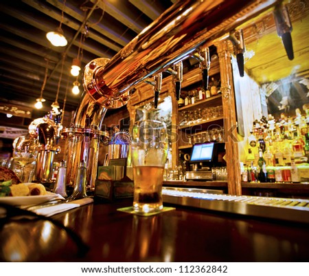 Pint of beer on a bar in a traditional style pub Royalty-Free Stock Photo #112362842