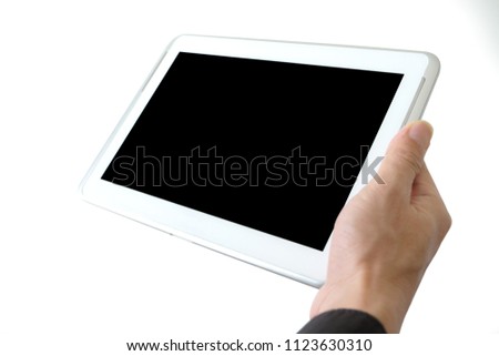 hands of people are using the tablet to find information and to entertain on black background.Concept of technology