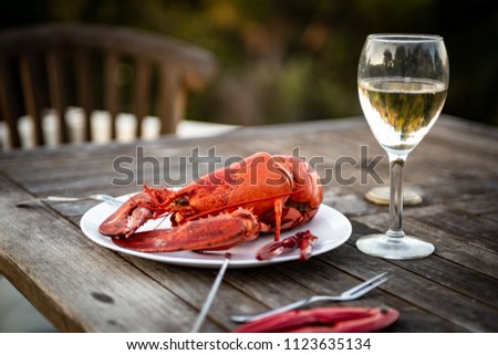 Fresh Steamed Maine Lobster with Wine and Utensils Royalty-Free Stock Photo #1123635134
