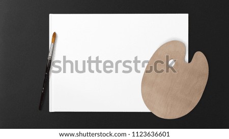 New wooden palette with an art brush, isolated on a white background and dark background