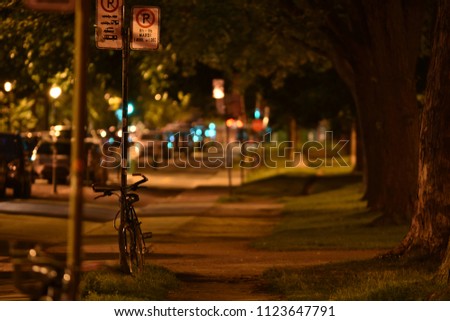 Bicycle parked by a park at night