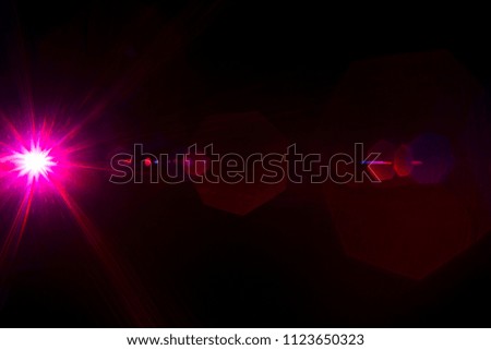 Camera lens flare by red laser light create hexagons of objective iris shapes of number depending on number of lens surface and interferent effect and moire on digital sensor on dark black background