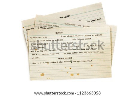 Old recipes typed on index cards, isolated on white.   Royalty-Free Stock Photo #1123663058