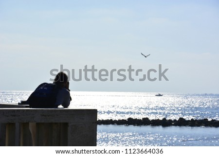 at pontile di ostia a man is taking photos of the sea
