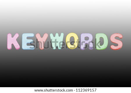 Keywords colorful of English letters, isolated on black background.