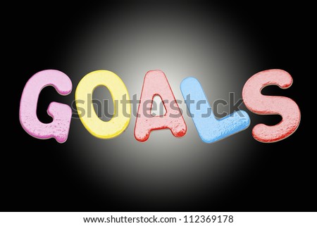 Goals colorful of English letters, isolated on black background.