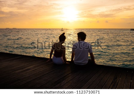 silhouette of couple  at sunset beach
