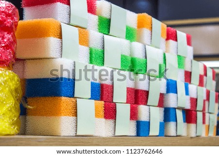 Sponge, a variety of color pack, put together on a wooden rack. Stocks for sale