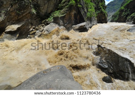Huge waves of muddy waters crash into each other in the Tiger Leaping Gorge rapids in Located 60 kilometres north of Lijiang City, Yunnan Province, China.