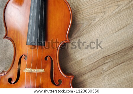 Violin on a wooden background. Close up. Copy spaces.