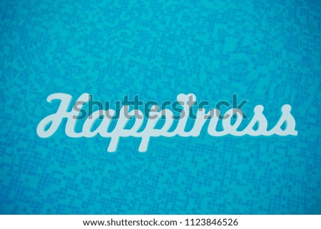 white wooden inscription of happiness with a heart floating on the water on a blue bright pool background