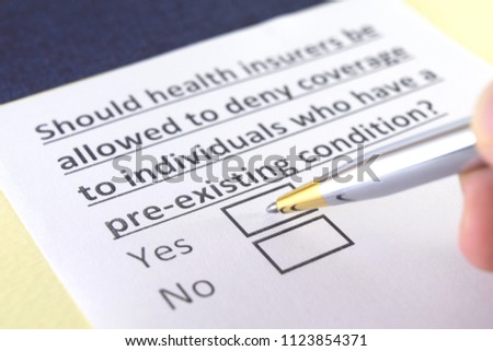 Should health insurers be allowed to deny coverage to individuals who have a pre-existing condition? Royalty-Free Stock Photo #1123854371
