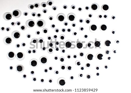 Googly eyes background image for craft cut-out or crop. Various sizes of fun kids art googly eyes. Royalty-Free Stock Photo #1123859429