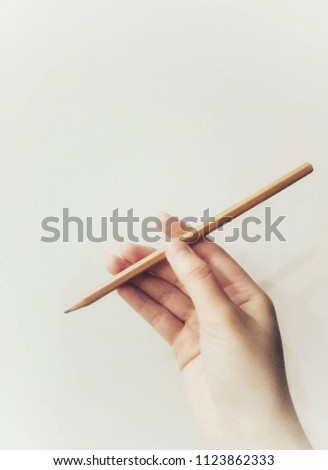 Catching a wooden pencil.