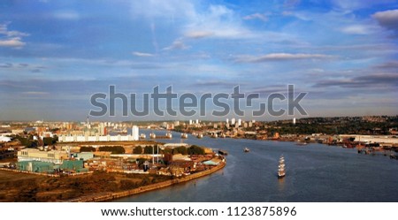 London Skyline, Bird's eye view, over blue sky, including Thames river and barrier.