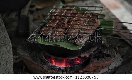 Grilled Pork (Steak) with Charcoal on Banana Leaf Traditional Thai Food