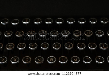 It’s an old and vintage typewriter with close up keyboard. Typewriter keys have circle shape. The typewriter vintage is obsolete. It’s collection for antique collectors. You will feel nostalgic