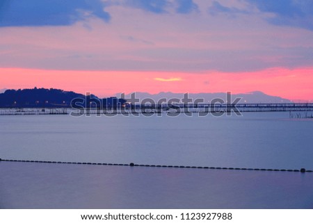 Long exposure shot of Lake view at Southern Thailand on sunset time background,Long exposure shot lake view with colored sky over lake on sunset time background.           