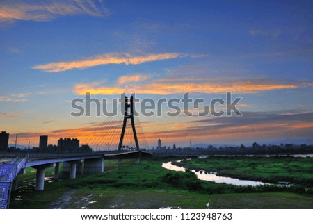 Taiwan, New Taipei City, the beautiful twists and turns of the river, reflecting the sky, bridges, sunrise and sunset city beautiful scenery.