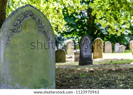 View of several tombstones in a small cemetery in the United Kingdom, in Norwich