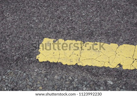 Road asphalt with yellow painted line