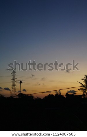 Morning dawn sky with urban village city silhouette in Indonesia