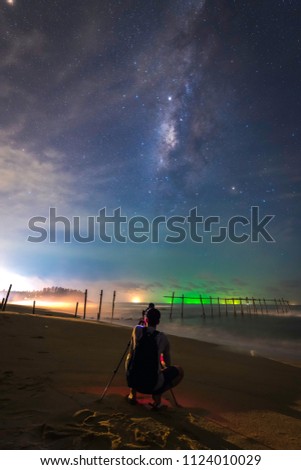 Landscape with Milky way galaxy , silhouette Photographer take photo at pilai beach Phangnga Thailand