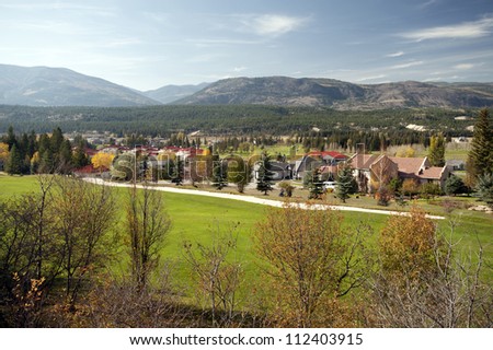 Radium Hot Springs - village and golf course under mountains Royalty-Free Stock Photo #112403915