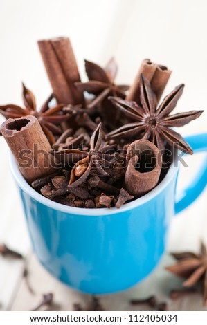 Espresso cup with cloves, cinnamon sticks and anise, studio shot