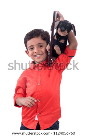 Portrait of a boy holding stuffed toy pet with frame.
