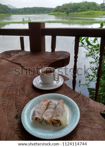 Afternoon tea with desert on a veranda overlooking a lake
