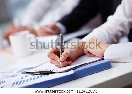 Close-up of female hand making notes Royalty-Free Stock Photo #112412093