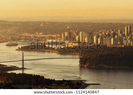 Vancouver sunrise with Lions Gate Bridge and skyscrapers in Canada.