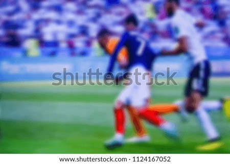 Soccer players at the pitch. Blurred soccer game. 