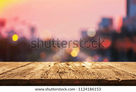 A front selective focus picture of wooden floor and blurred traffic light background