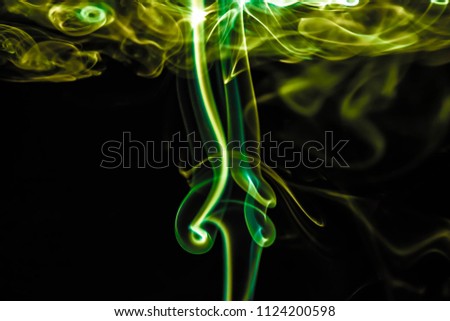 Magical mystery of colorful light smoke on dark , science background for your creative and design. Abstract of beautiful light smoke on black background.