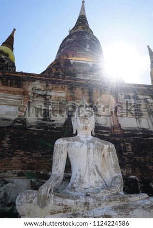 Stone Buddha statue in old temple in Ayutthaya Thailand