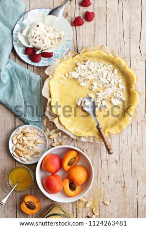 Summer tart with apricots and raspberry. Overhead view.
