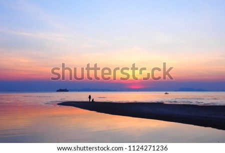 Romantic silhouette couple watching  beautiful sunset on the beach at  Nathon Beach  Samui Thailand