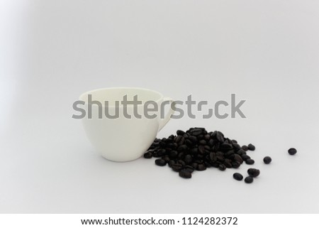 white ceramic cup and coffee bean on white background