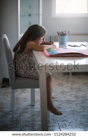 Little girl drawing on the table