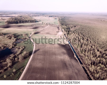 drone image. aerial view of rural area with freshly cultivated agriculture fields. sunny spring day. latvia - vintage film look