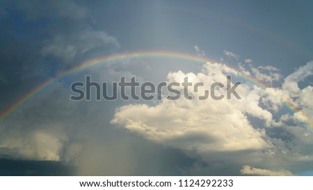 A colorful rainbow on the sky after thunderstorm