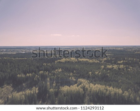 drone image. aerial view of rural area with fields and forests in cloudy spring day. latvia - vintage film look